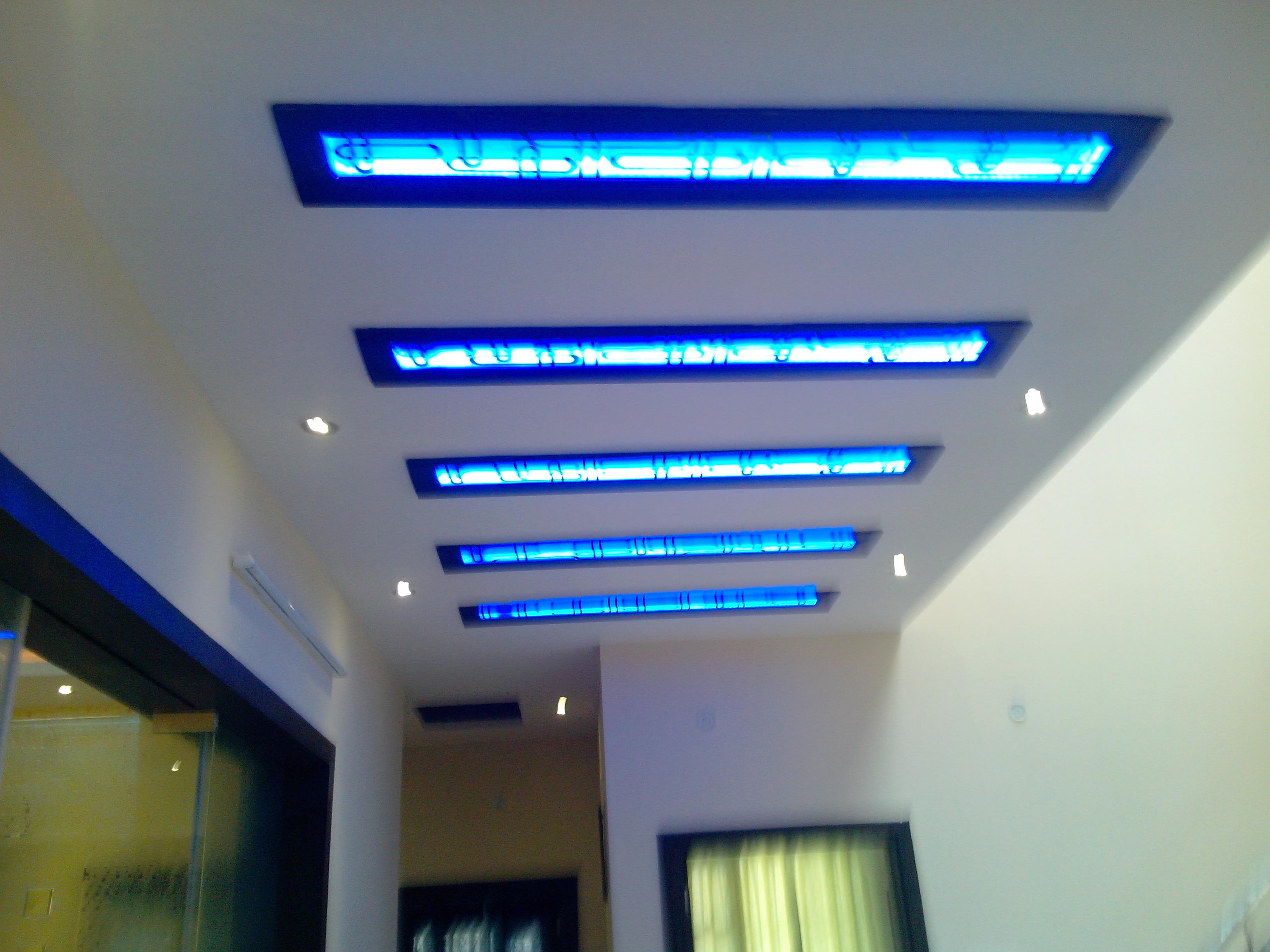 Ceiling Design For A Lobby Area With Blue Cove Lights Covered With