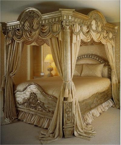 Wrought Iron Canopy  Frames on Dark Wood Carved Table Beside The Bed Give Ethnic Style To The Room