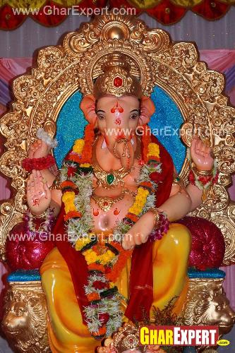 Bright coloured Ganpati decoration with garlands