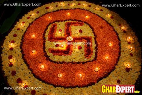 Flower arrangement representing swastik with diyas on diwali