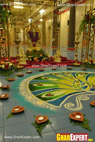 Colorful rangoli with diyas arrangement on Ganesh Chaturthi